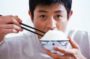 Man Eating Bowl of Rice