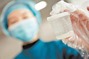 asian-nurse-holding-up-bottle-of-donated-sperm