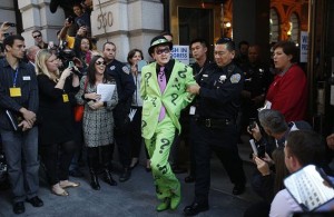 A man dressed as the Riddler is taken away after being apprehended by leukemia survivor Miles dressed as "Batkid" (not pictured) during a day arranged by the Make-A-Wish Foundation in San Francisco