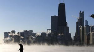 A man is silhouetted against the arctic sea smoke rising off Lake Michigan in Chicago