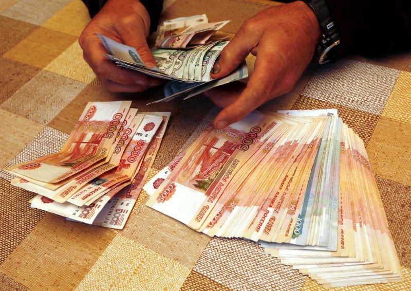 A local businessman counts Russian roubles at a tourist base outside Krasnoyarsk